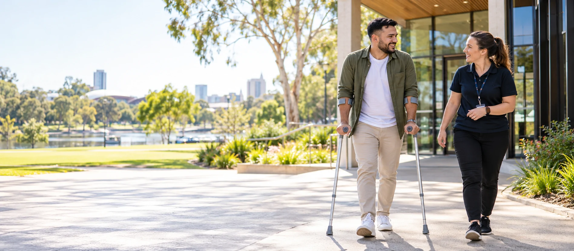 A person using forearm crutches participating in the community with support