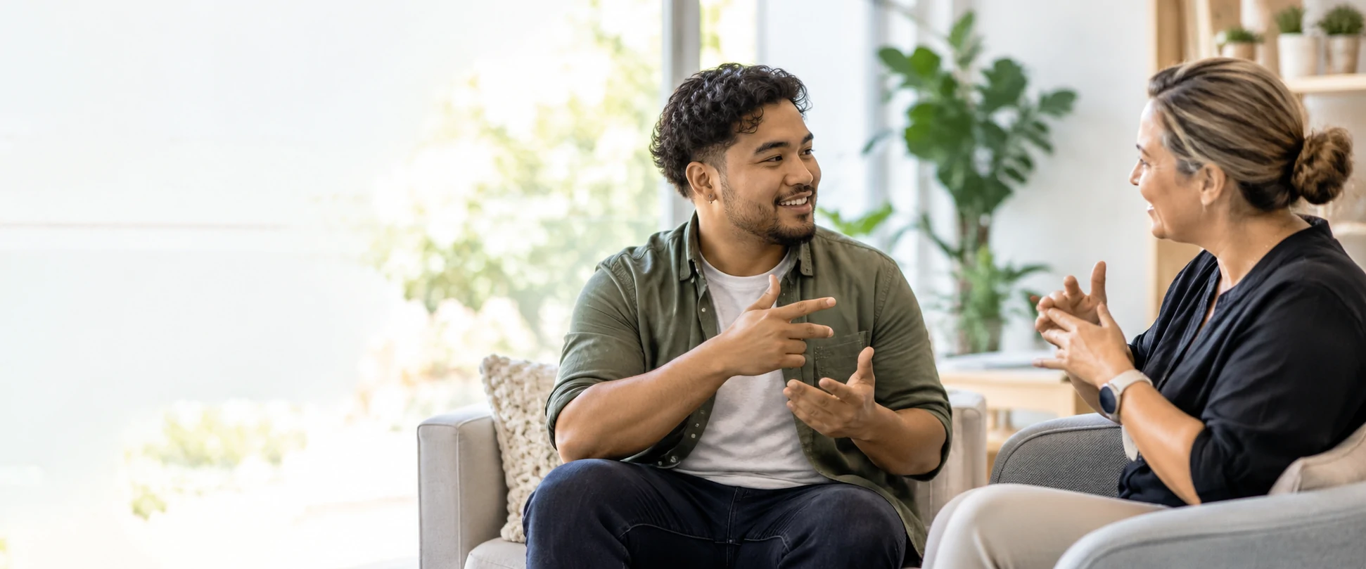 A Deaf or hard-of-hearing person communicating in sign language with a support worker
